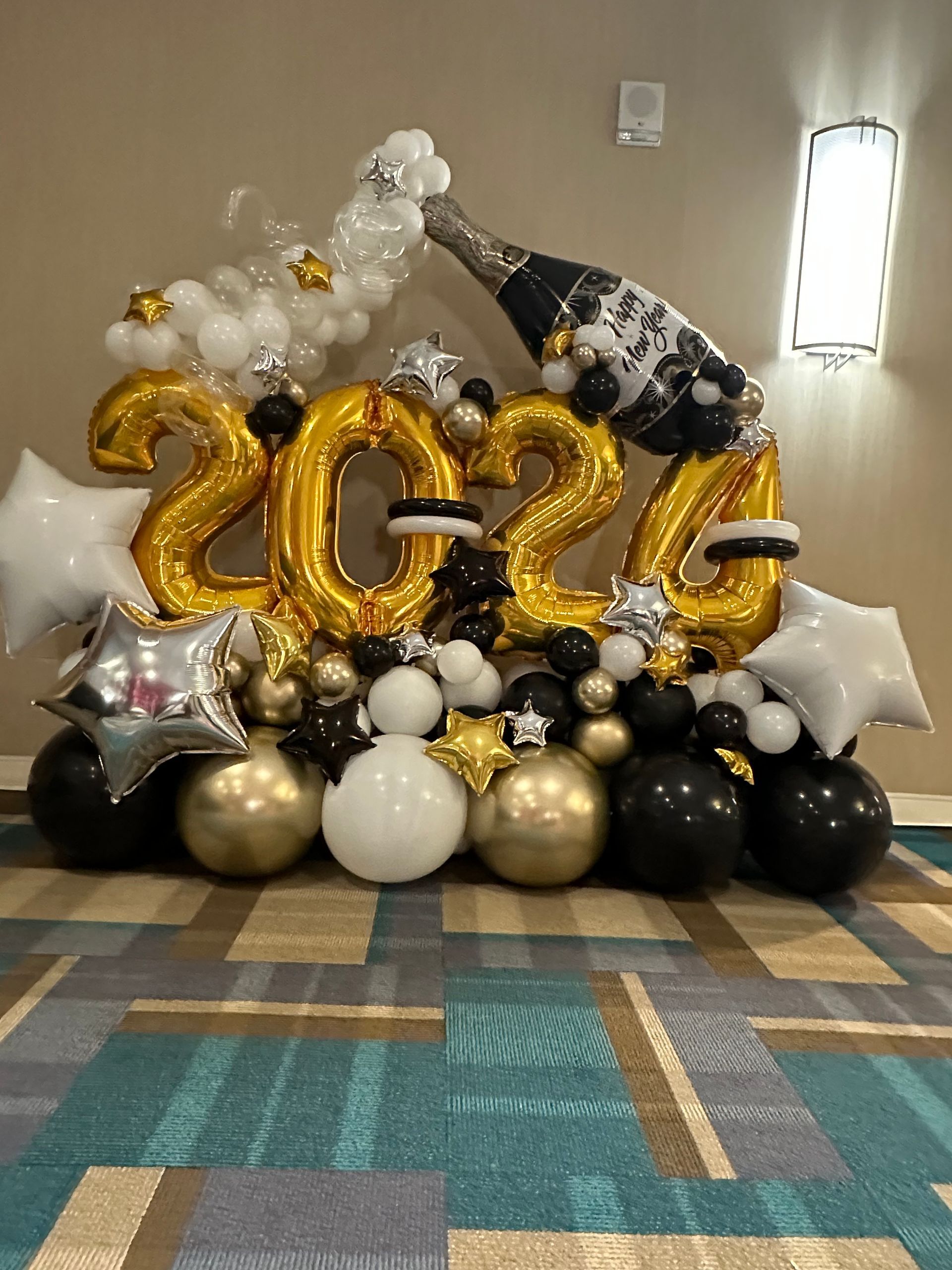 A bunch of balloons are sitting on the floor in a room.