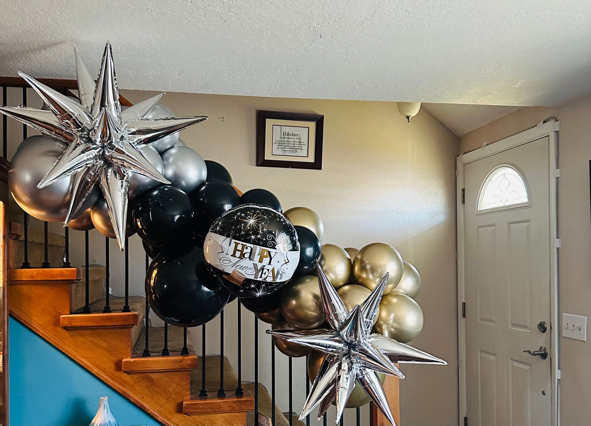 A staircase decorated with balloons and stars for a new year 's eve party.