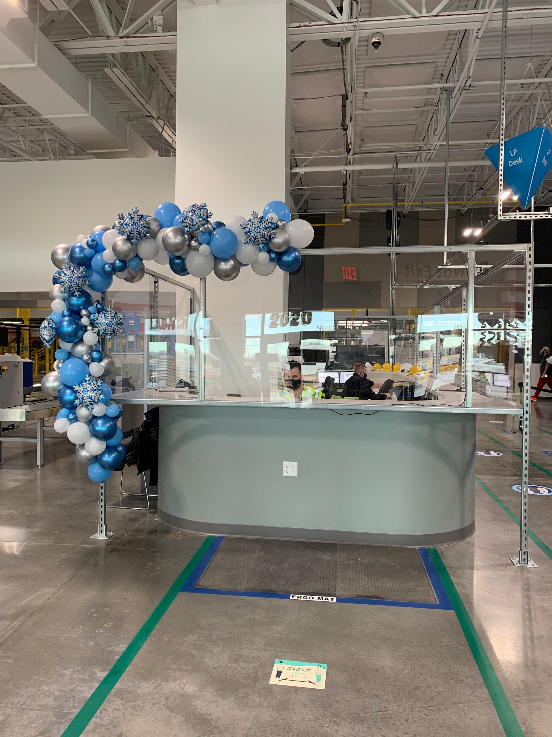 A balloon arch is hanging over a counter in a store.