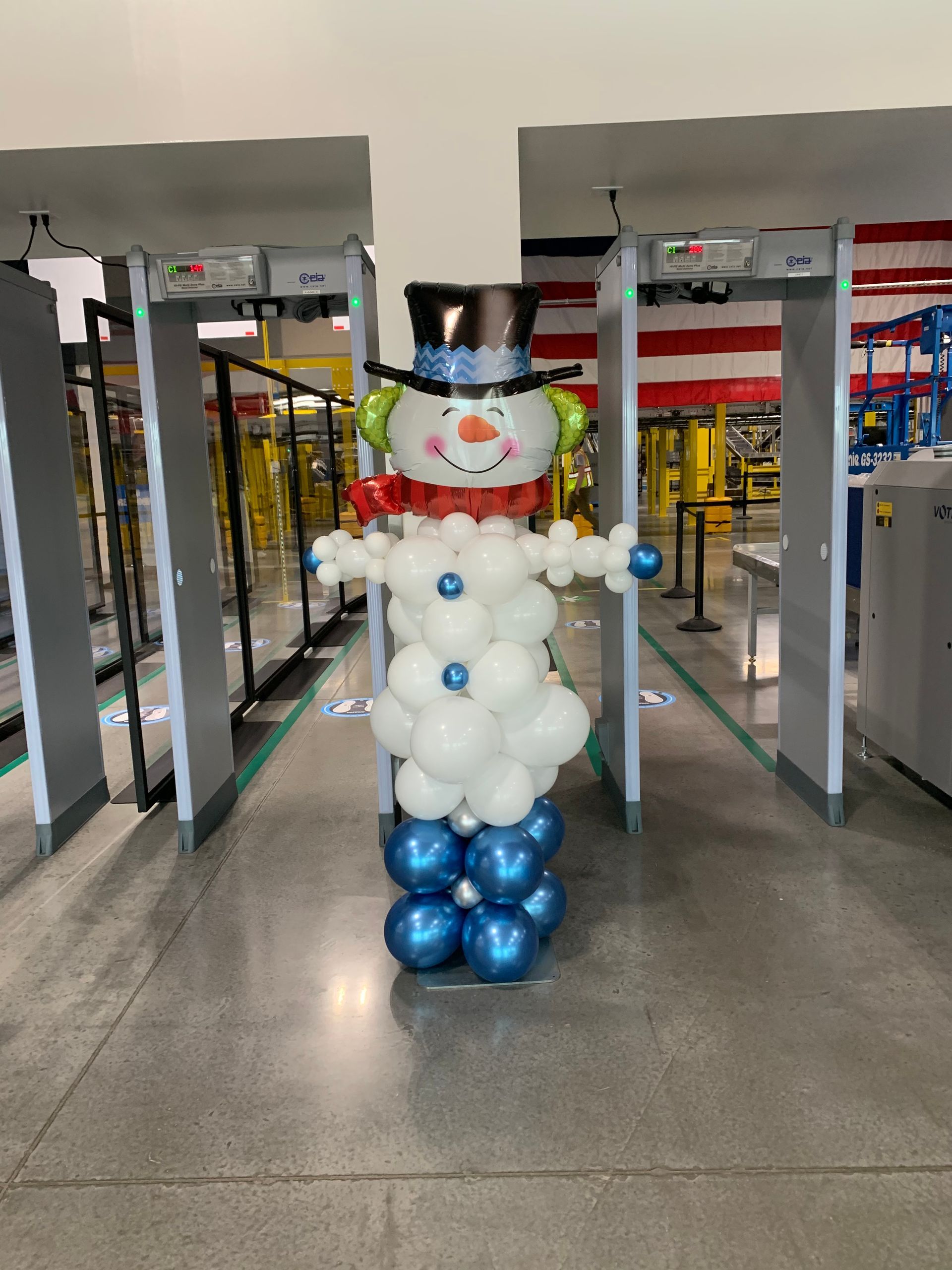 A snowman made out of balloons in a hallway