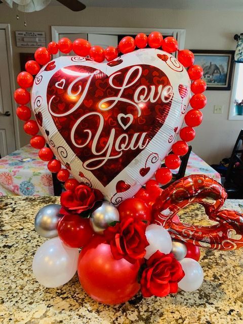 A heart shaped balloon with the words `` i love you '' on it