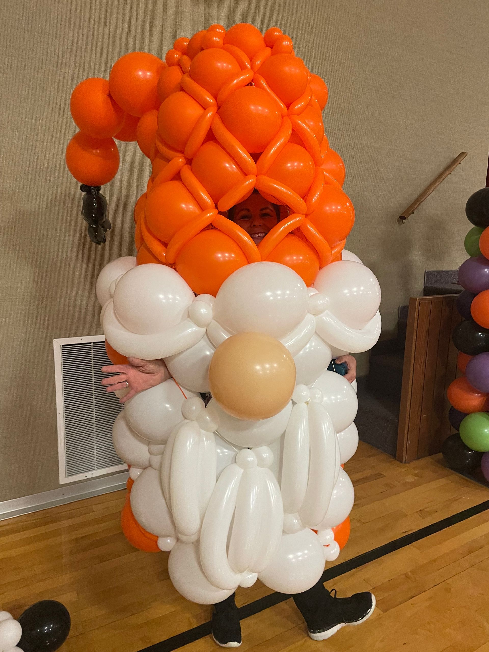 A person dressed as a gnome made out of balloons