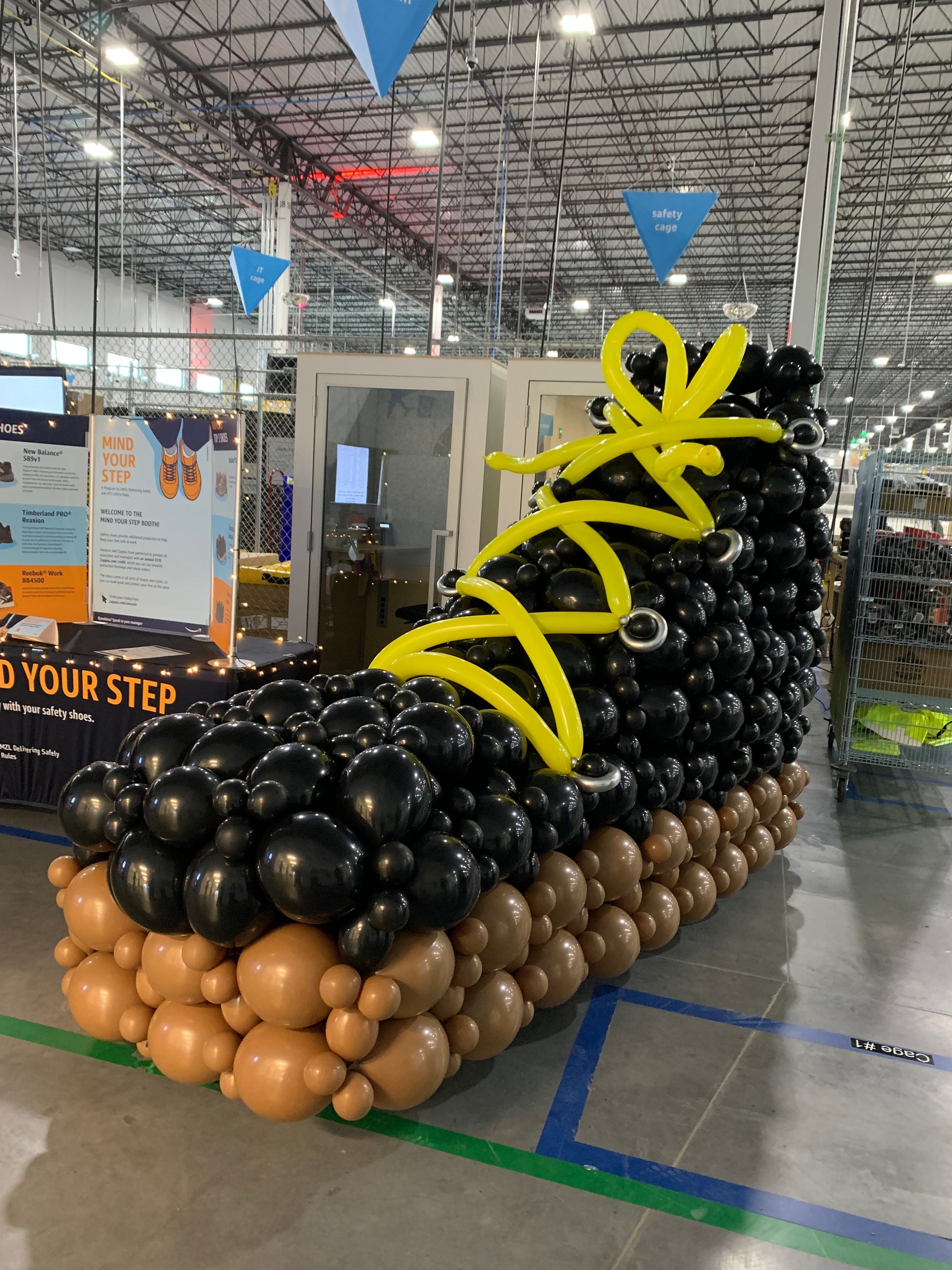A shoe made out of balloons in a warehouse