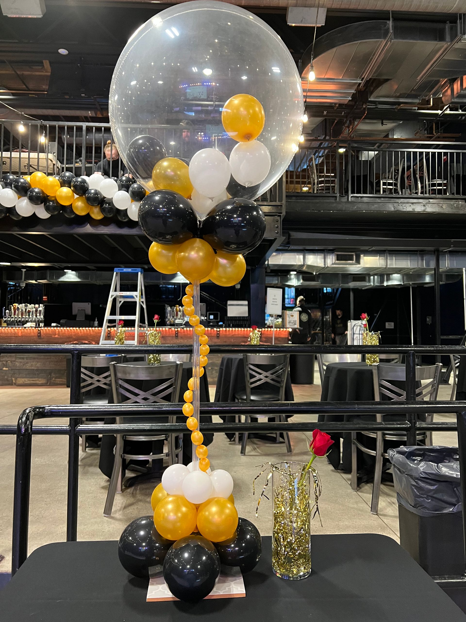 A table with balloons on it and a large balloon on top of it.