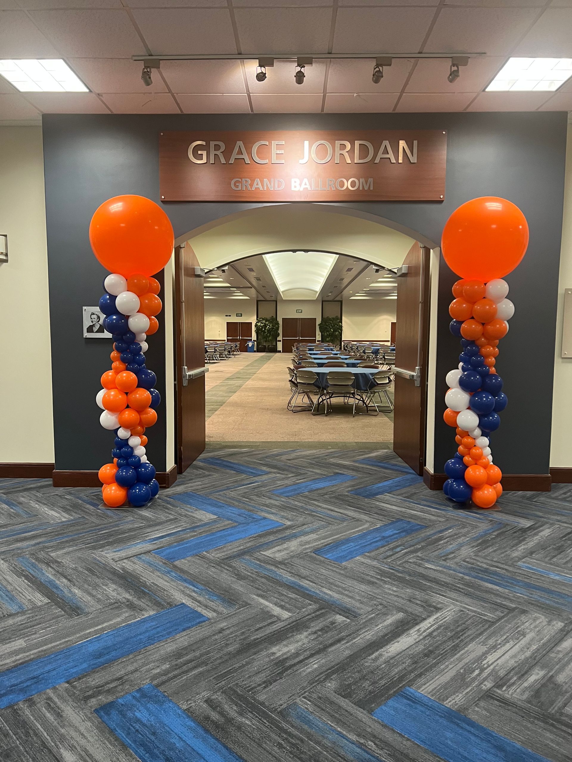 A hallway with balloons and a sign that says grace jordan