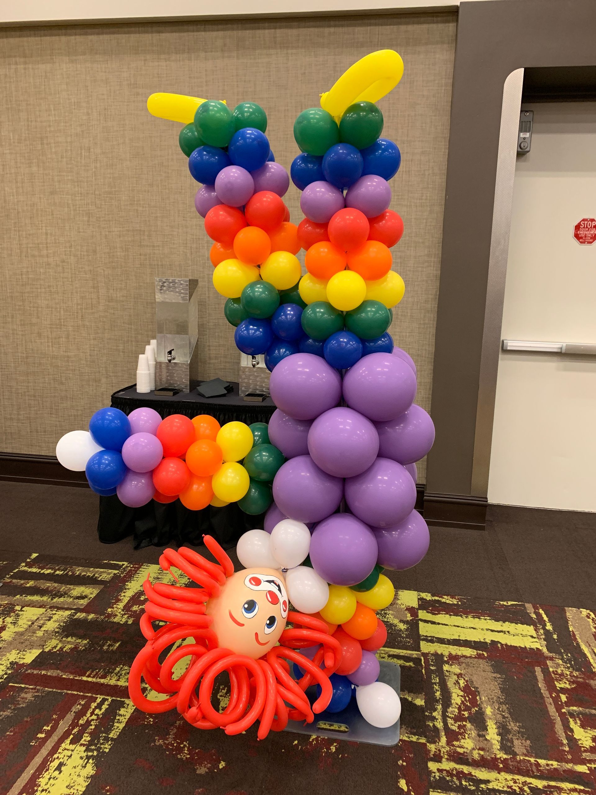 A clown made out of balloons in the shape of the letter k
