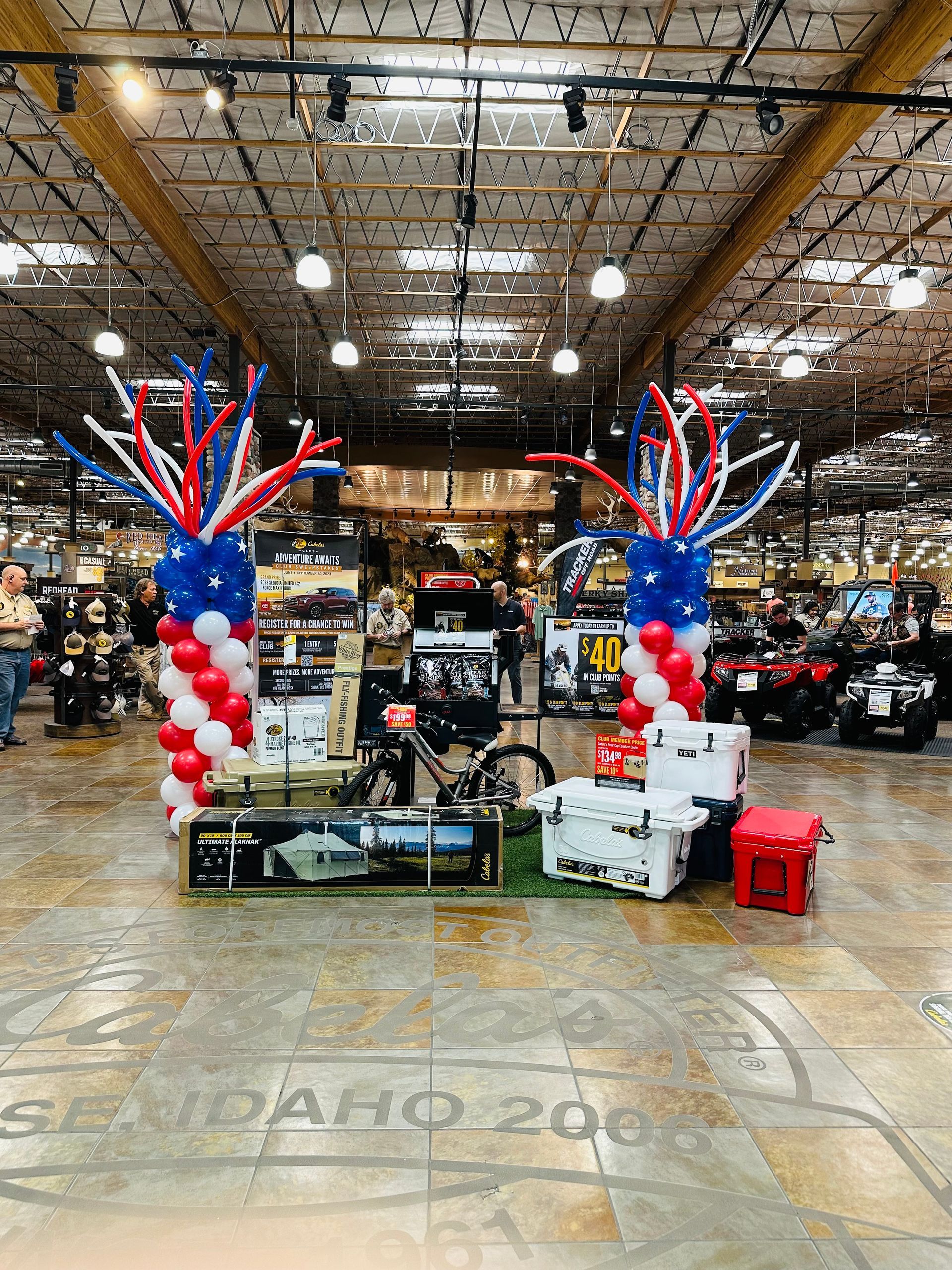 There are balloons in the shape of a pineapple in the middle of the room.