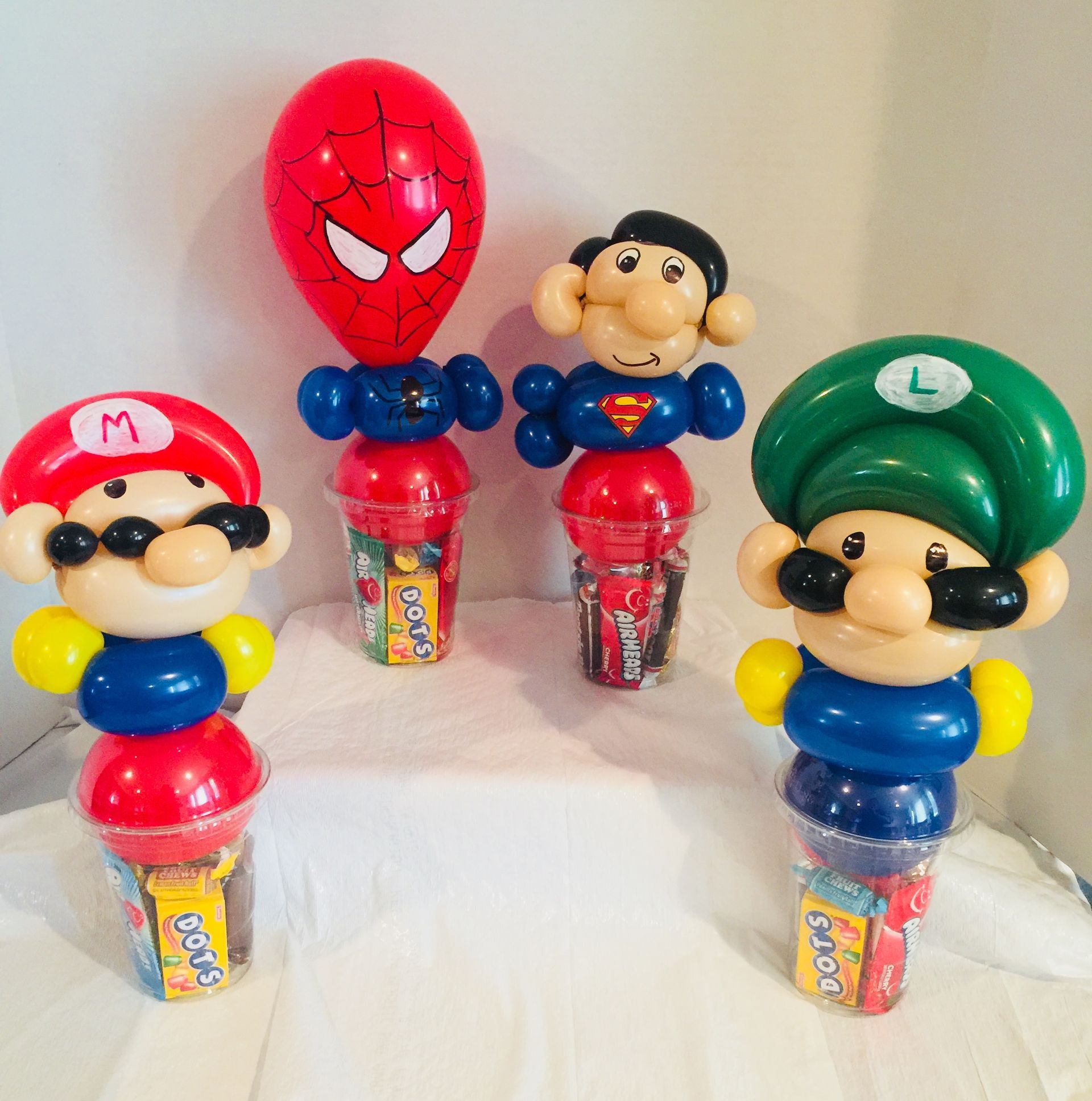 A group of mario balloons are sitting on a table