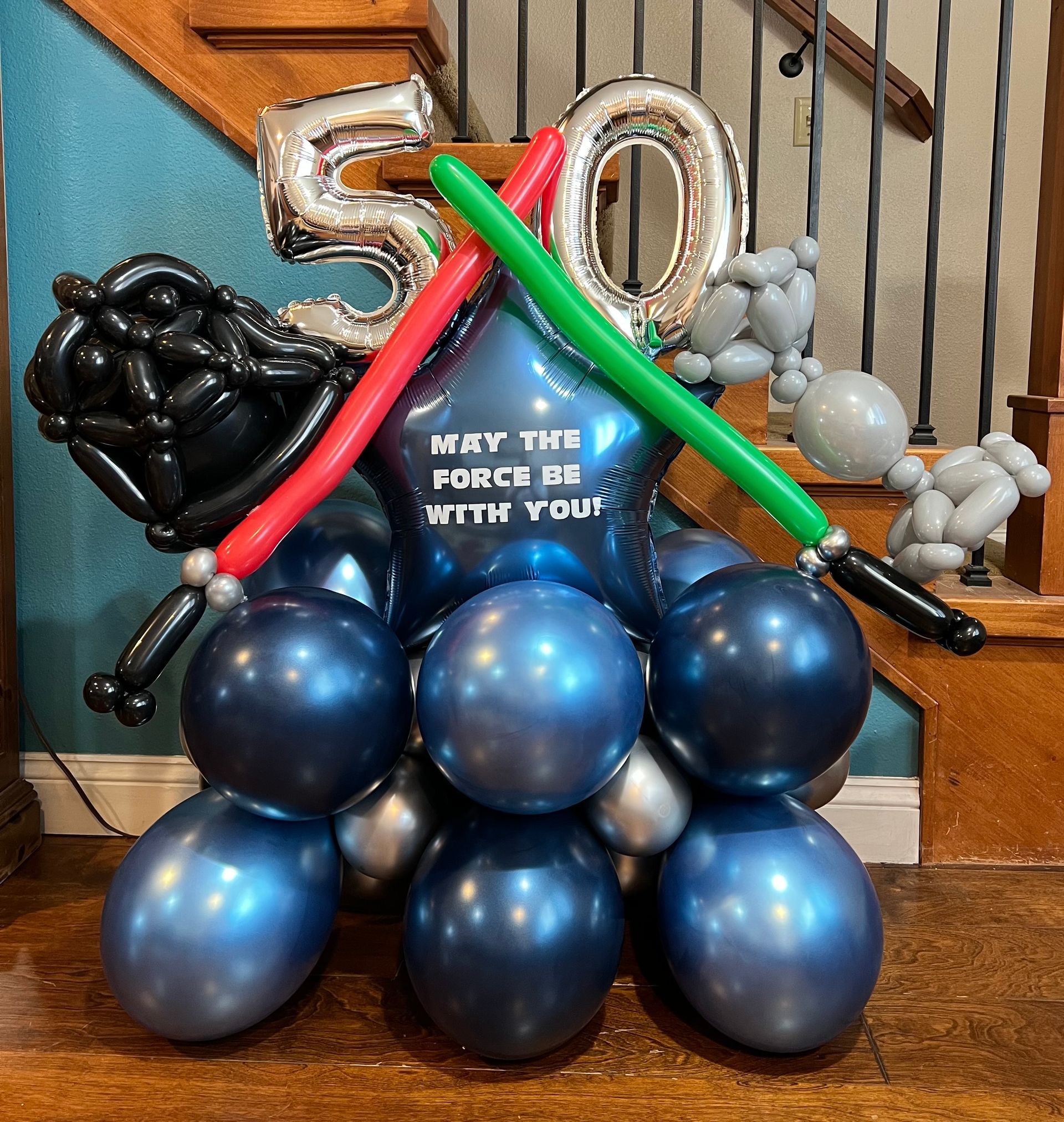A bunch of balloons with the number 50 on it