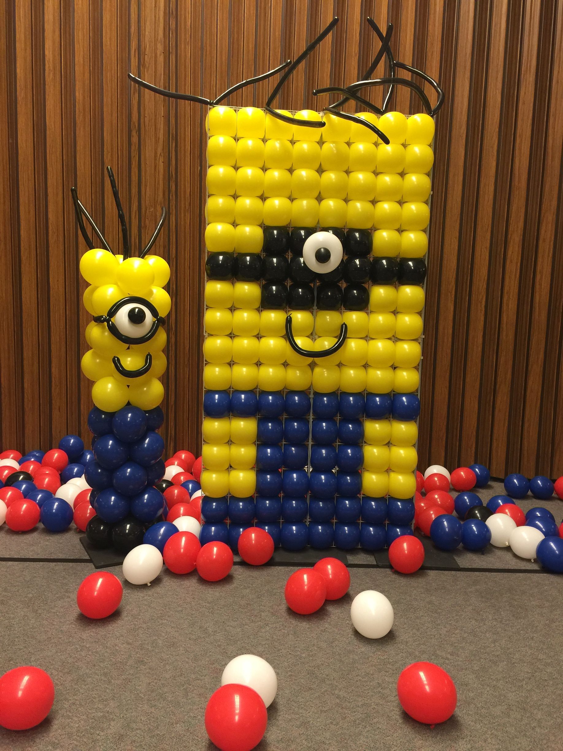 A wall made of balloons in the shape of a minion