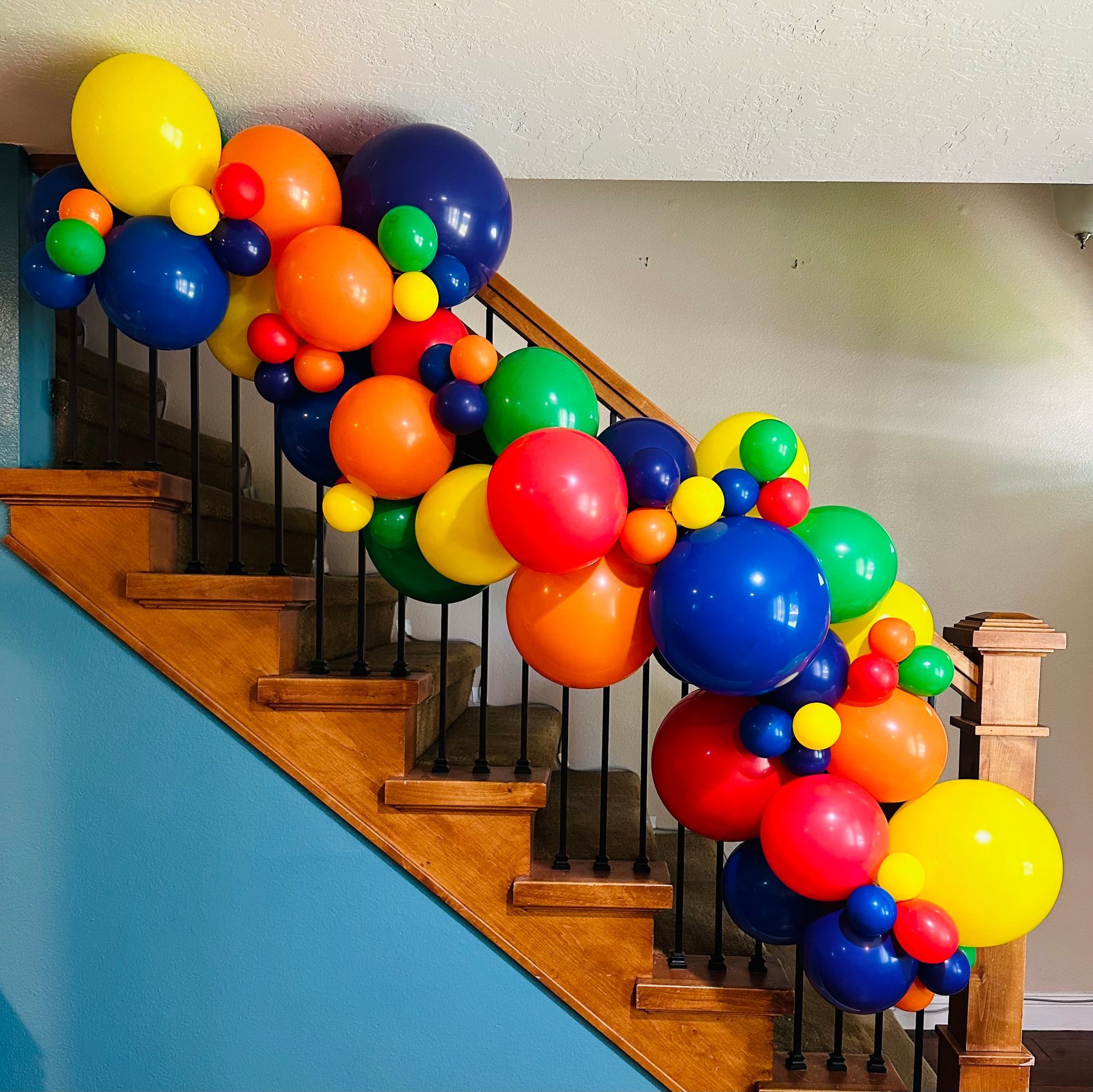 A staircase decorated with colorful balloons for a birthday party.