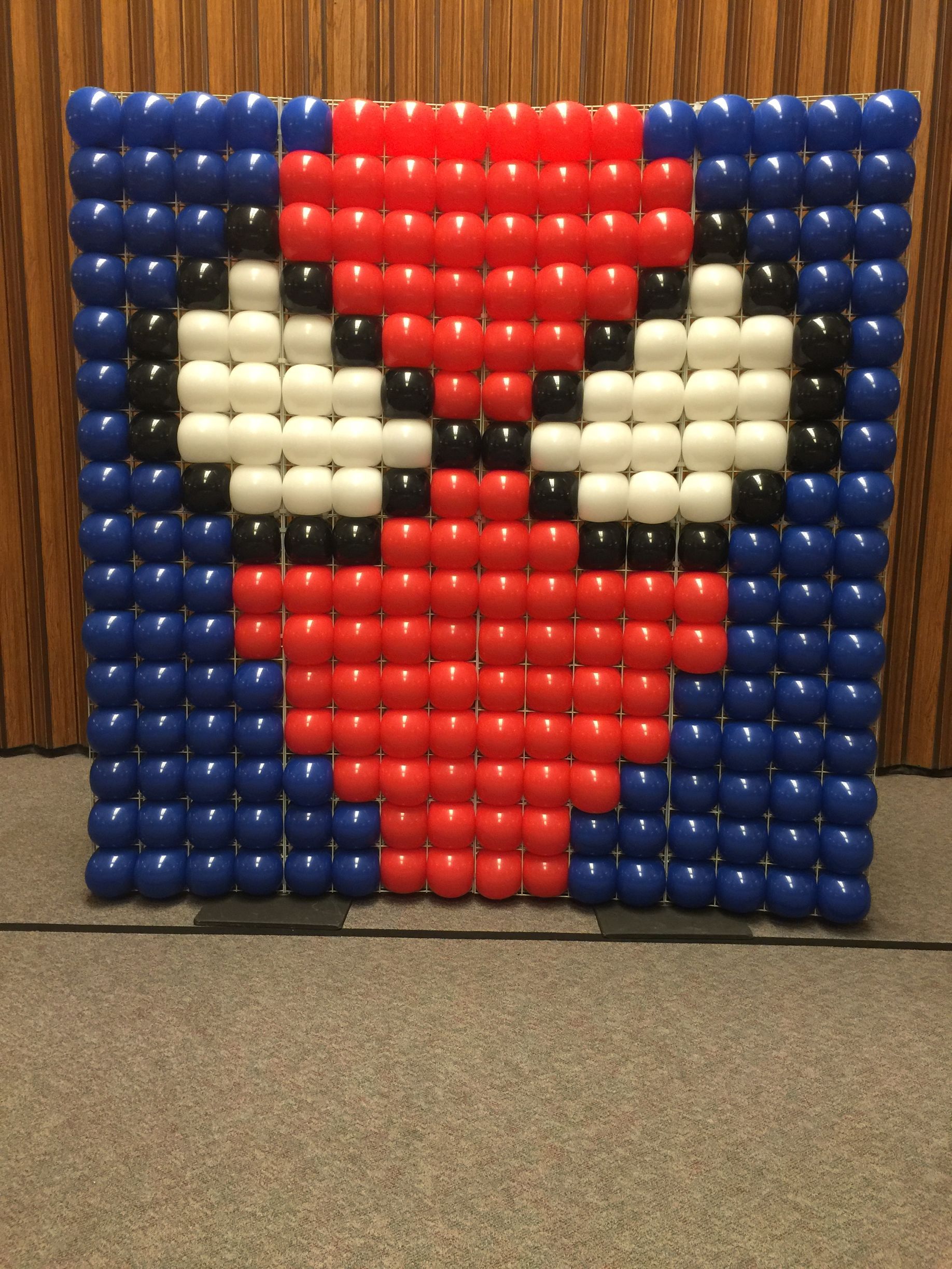 A picture of a spiderman face made out of balloons