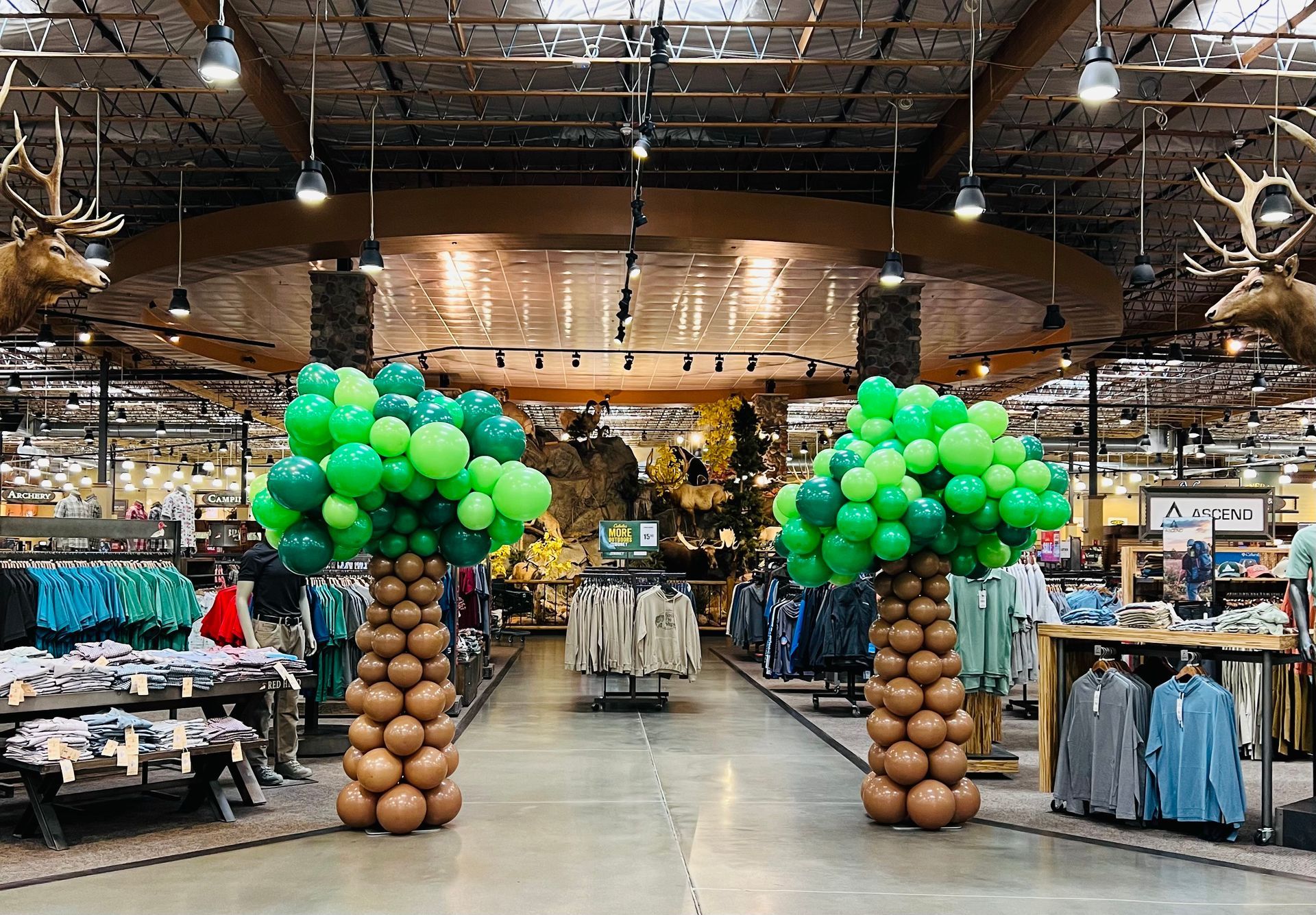 A store filled with balloons in the shape of trees.