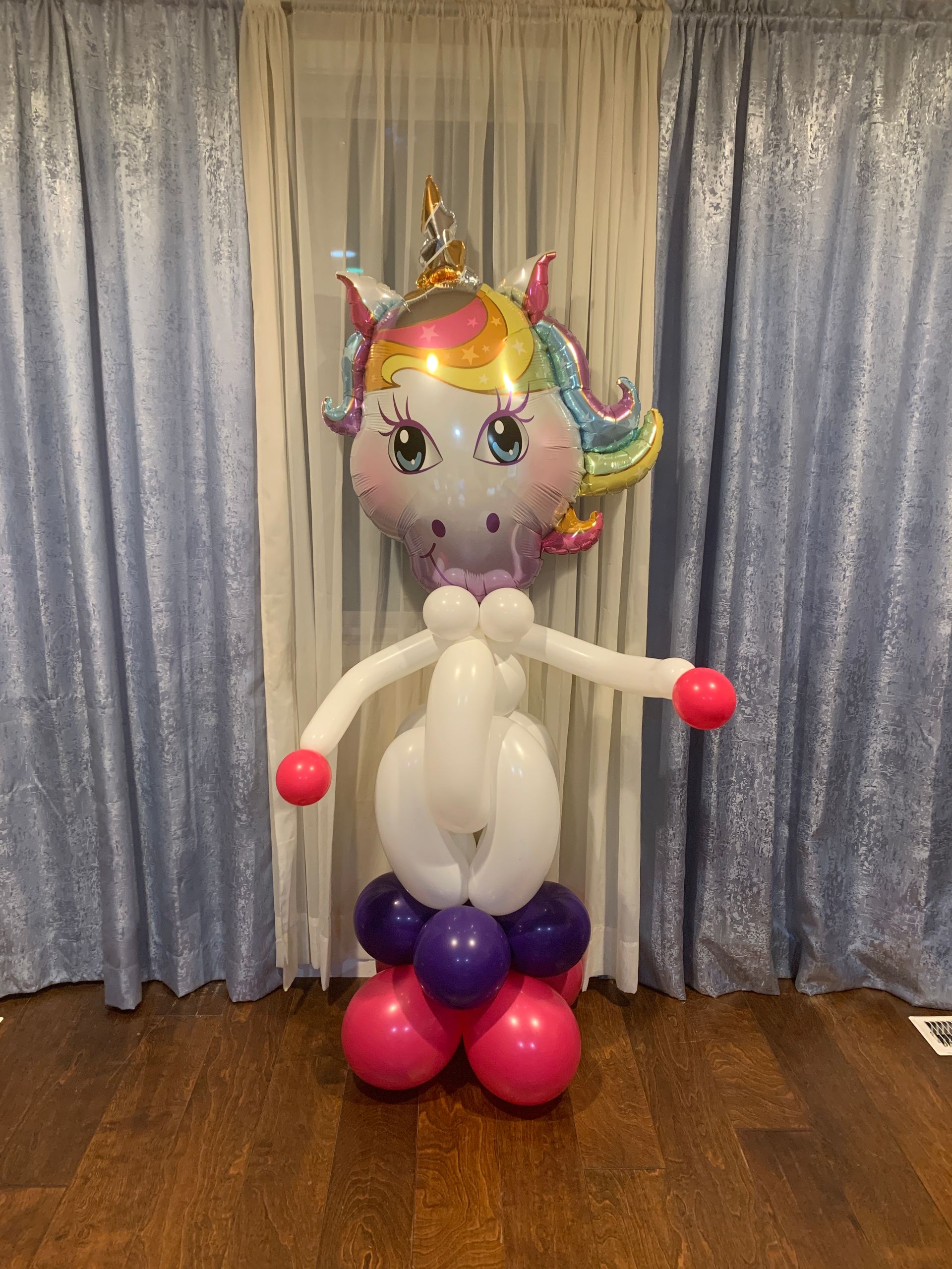 A balloon shaped like a unicorn is sitting on top of a table.
