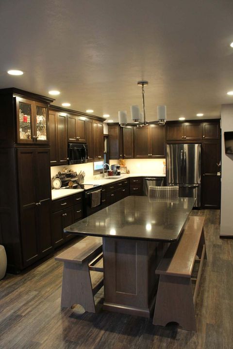 dark wood kitchen cabinets and dark island countertop
