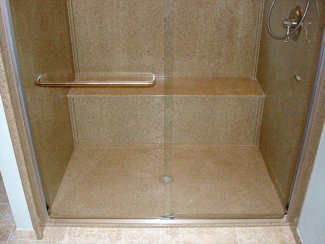 onyx collection stand in shower with ledge