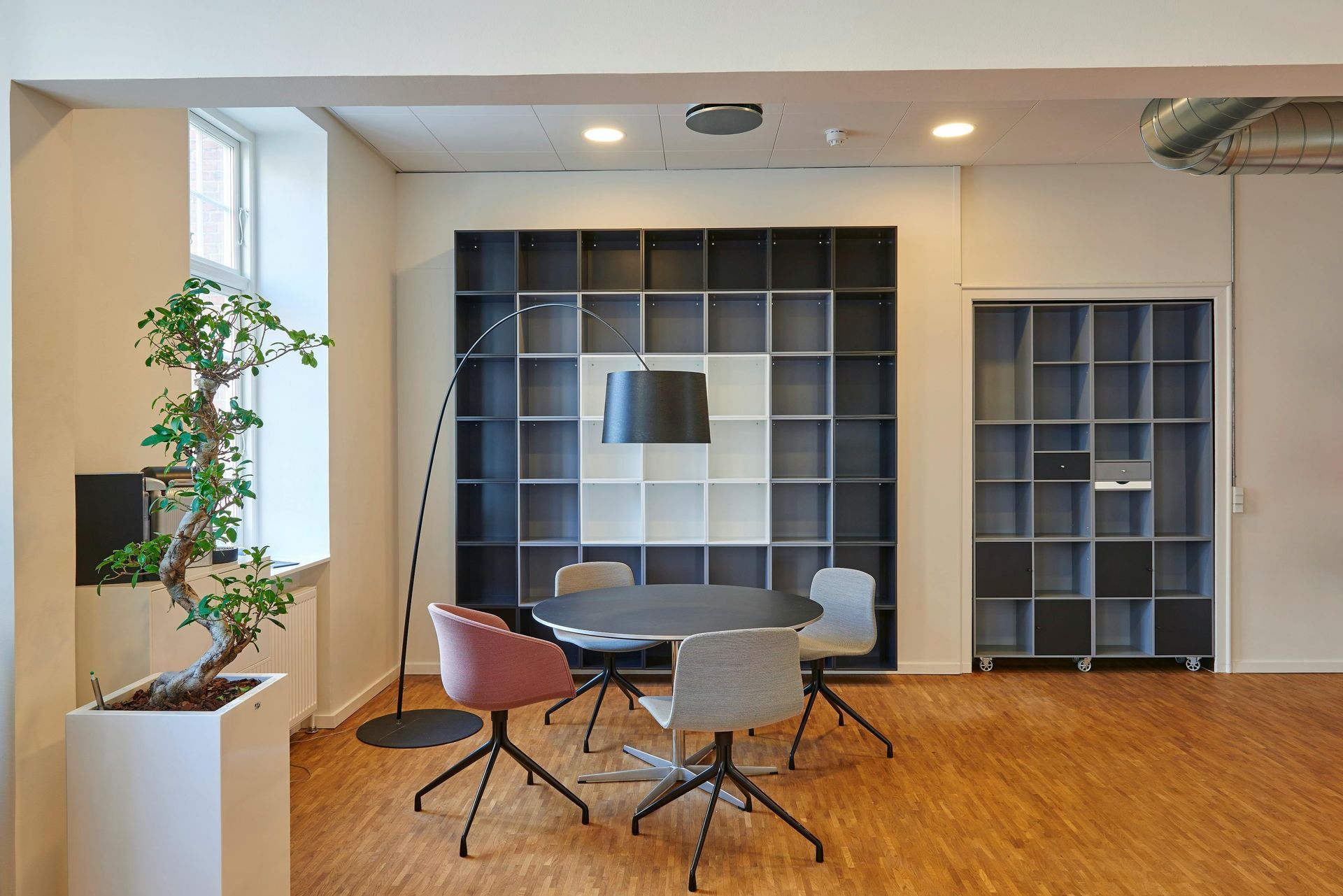 There is a table and chairs in the middle of the room.