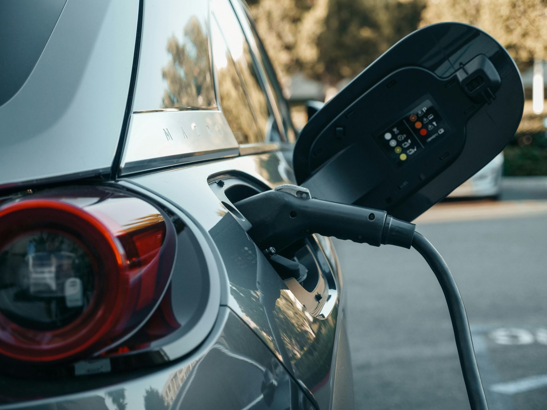 An electric car is being charged at a charging station.