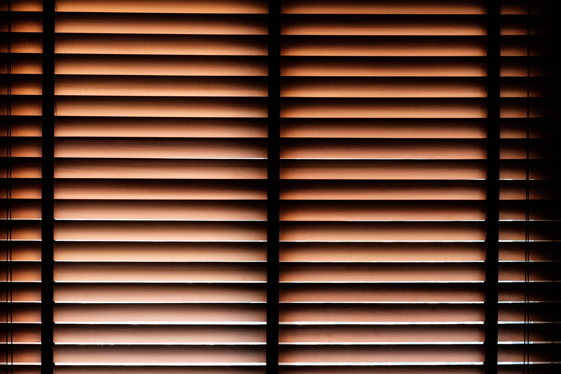 A gorgeous set of wood blinds with light peeking through at Fabric Works near Spokane ,Washington(WA)