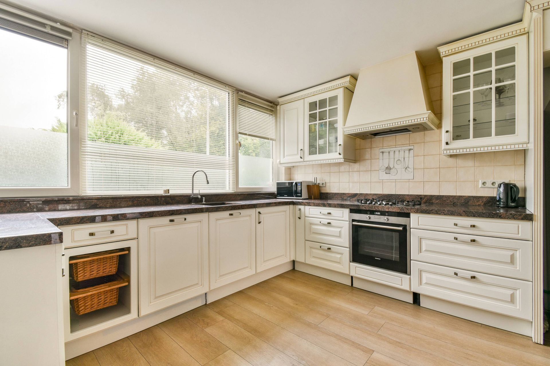 A kitchen with three windows and three sets of window blinds at Fabric Works near Spokane ,Washington (WA)