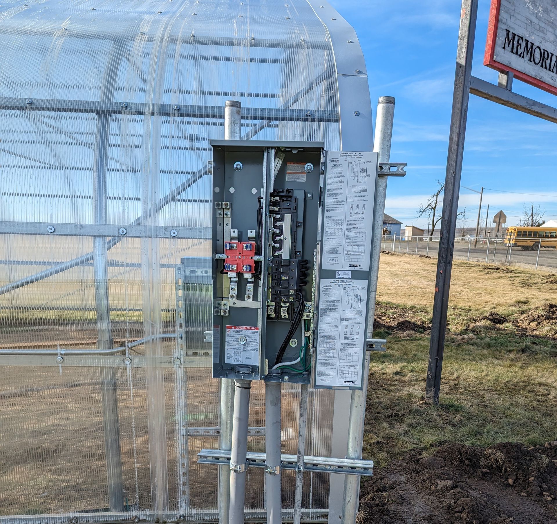 A greenhouse with a sign that says memorial on it