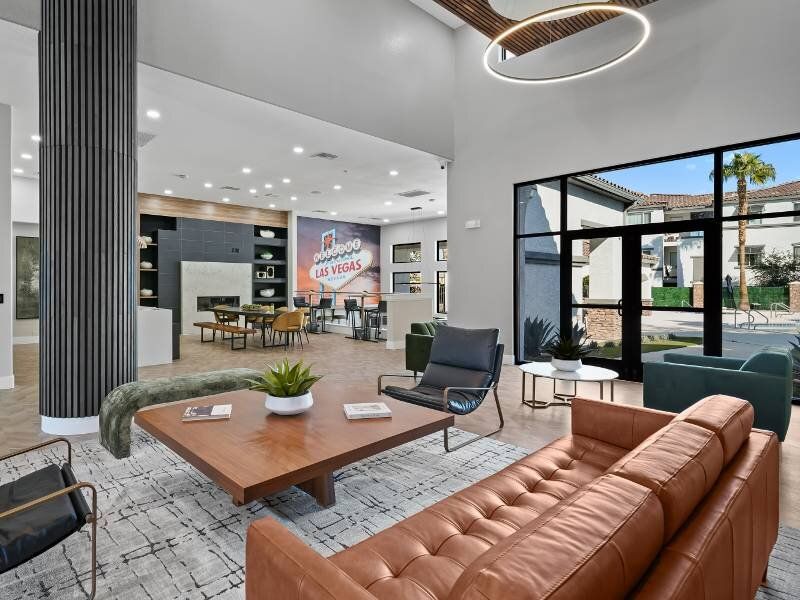 Spacious modern apartment community lobby with seating area and large windows.