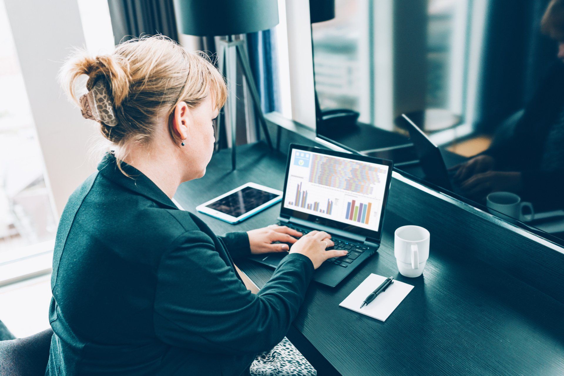 Woman Works in Front of Laptop – Overland Park, KS – Haynes Consulting Group
