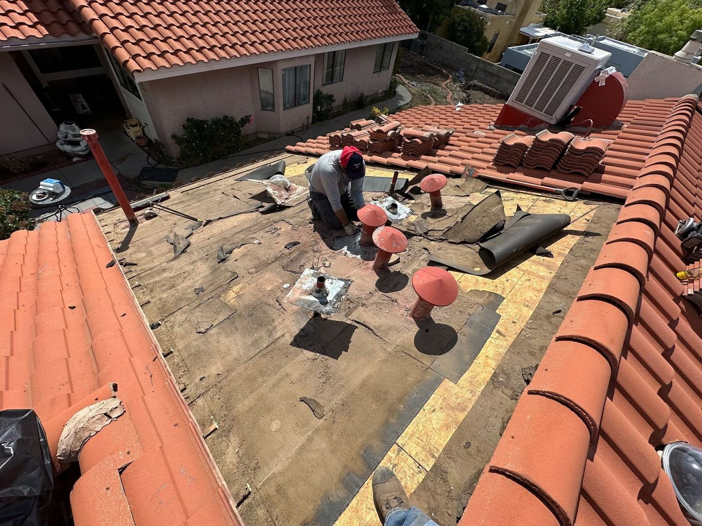 Overhead view of a house with a gray shingle roof and a chimney.
