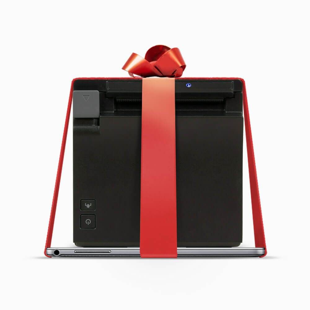 a printer is wrapped in a red ribbon and tied with a red bow .