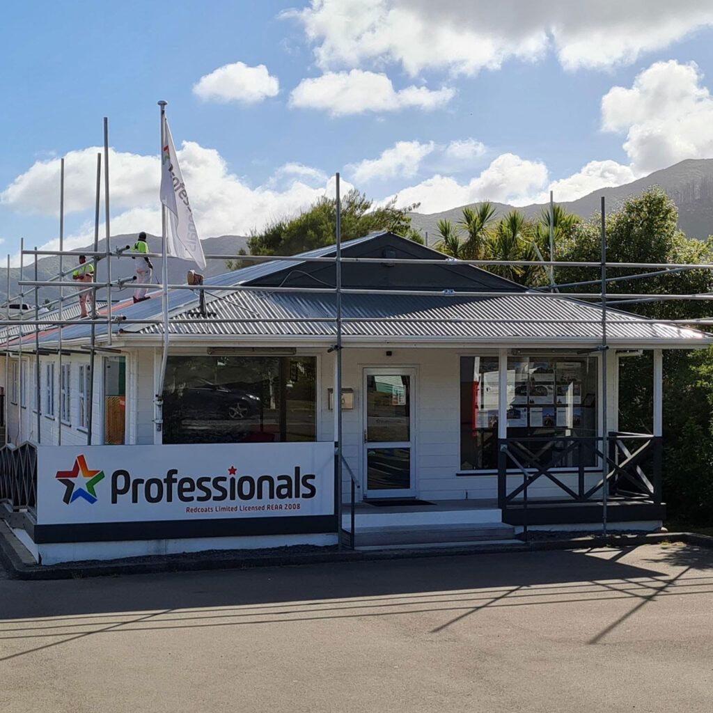 A white building with a sign that says professionals.