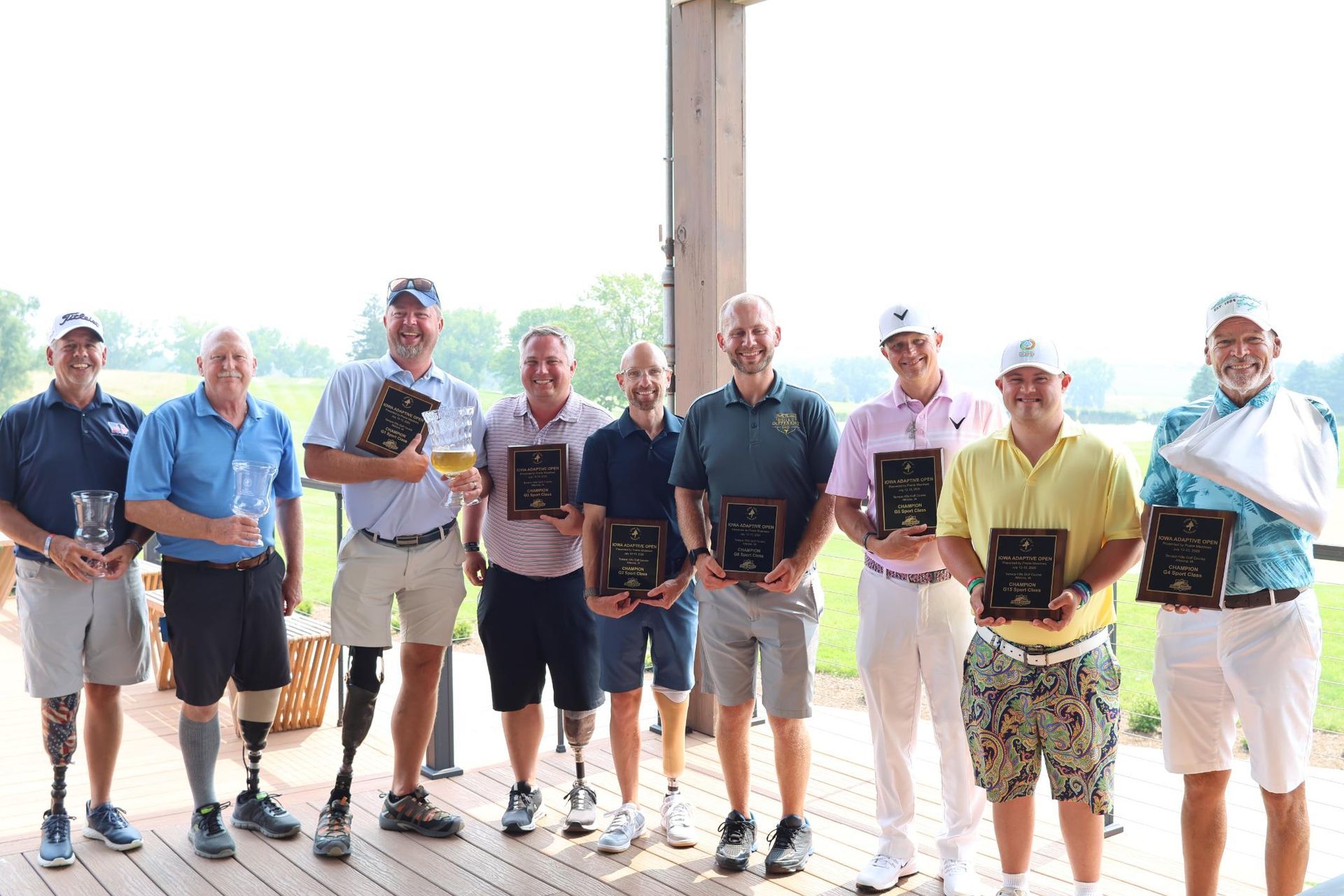 A group of people standing next to a golf cart on a golf course.