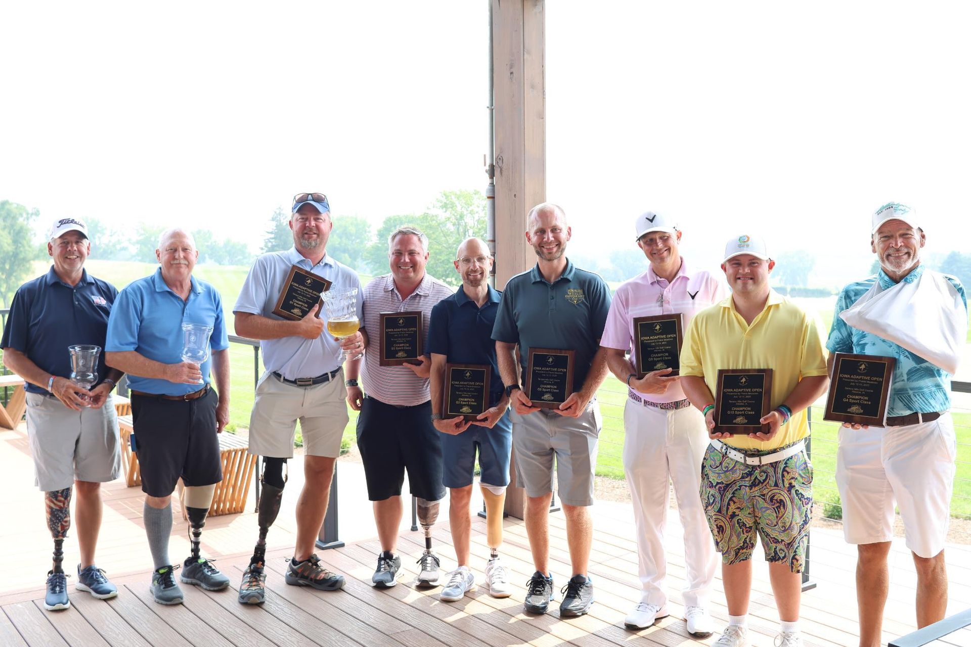 A group of people are posing for a picture on a golf course.