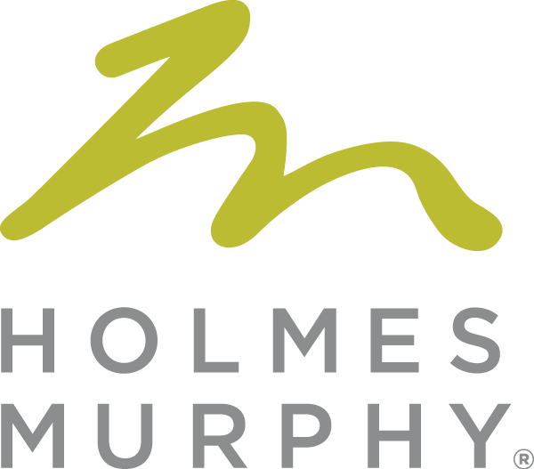 A logo for holmes murphy with a green letter m