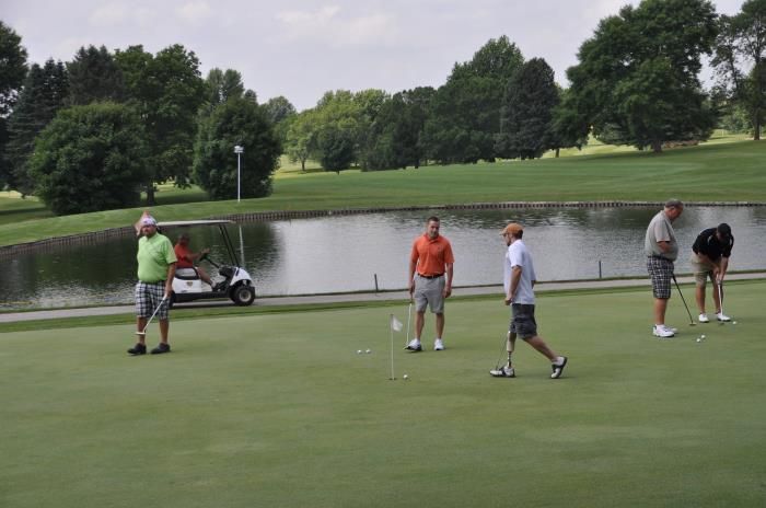 A group of men are playing golf on a golf course