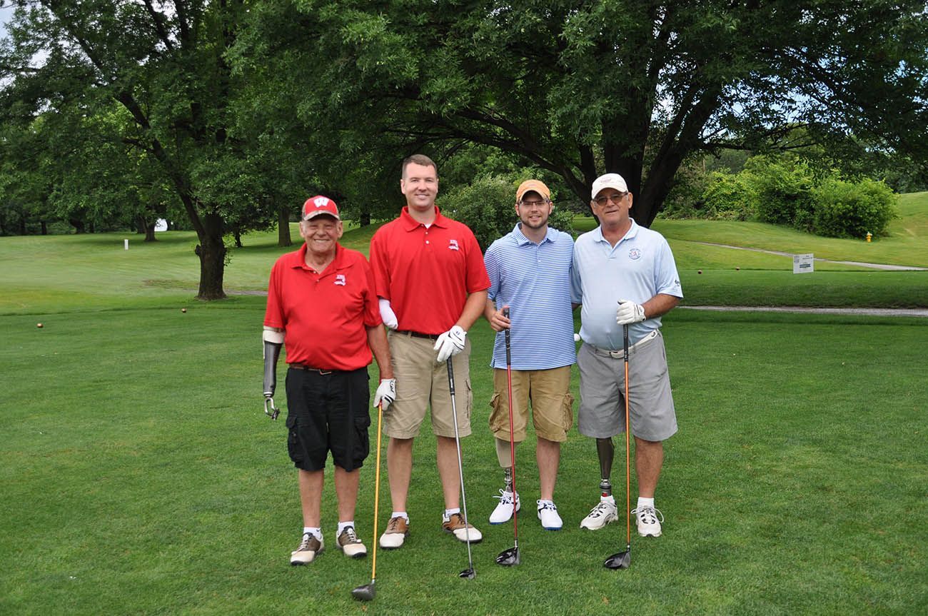A group of men are posing for a picture on a golf course.
