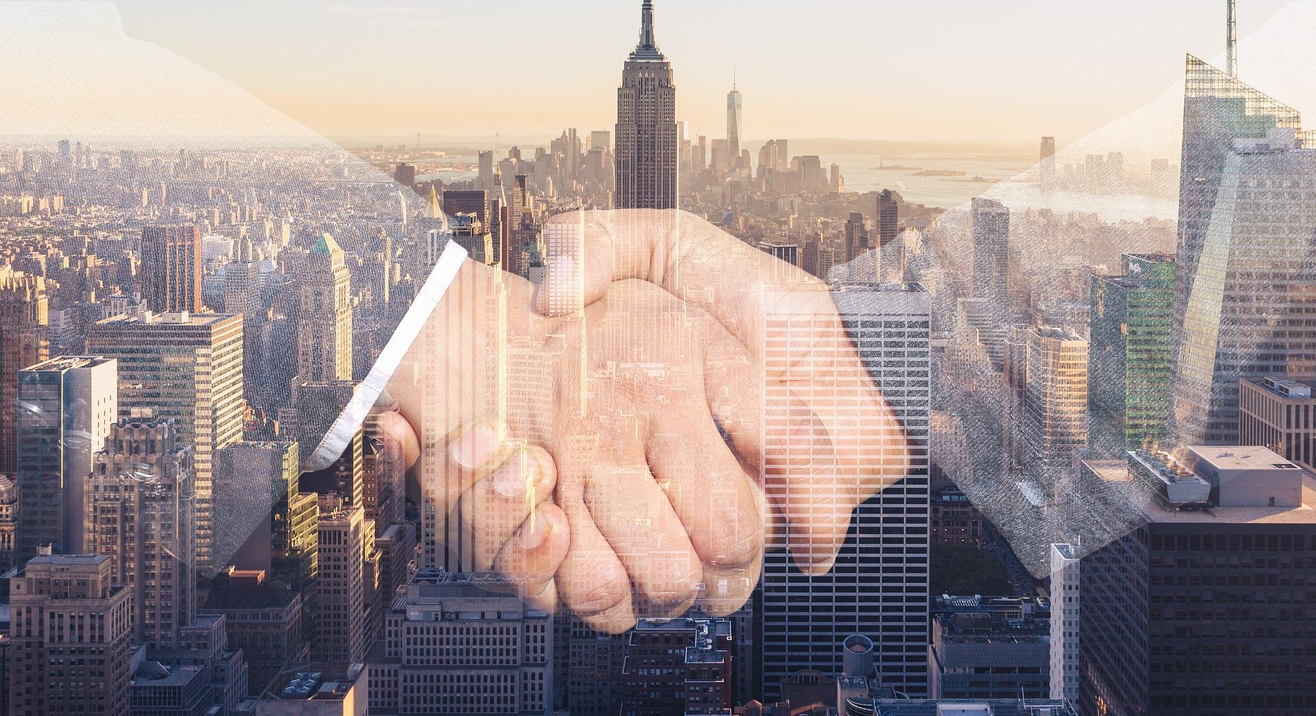 Handshake overlaid on a New York City skyline, symbolizing partnership and business.