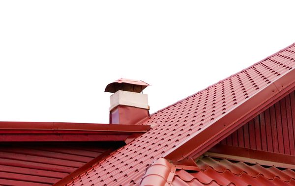 A red roof with a chimney on top of it.