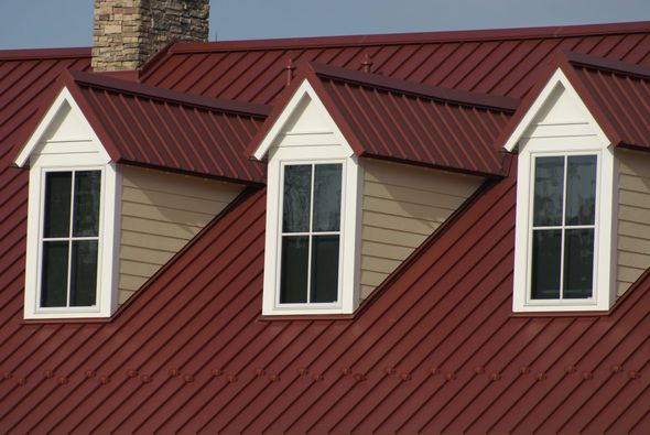 A red roof with three windows on it