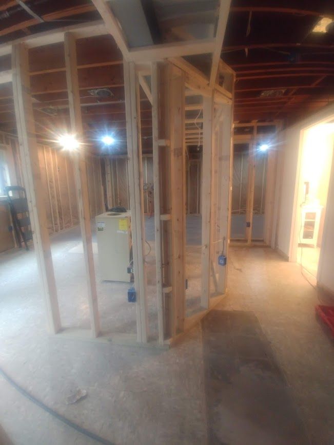 Interior basement framing for rooms with exposed wooden studs.