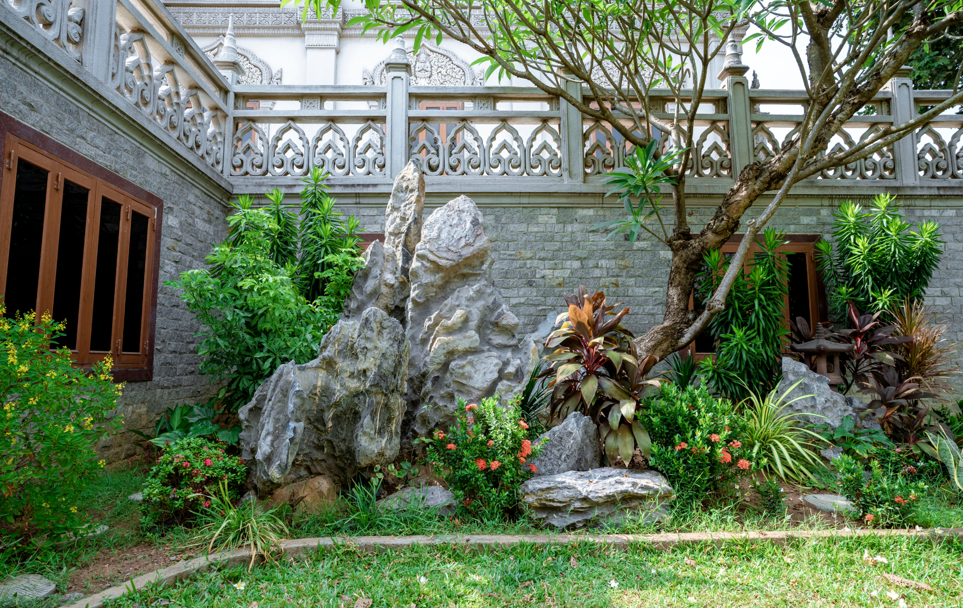 There is a large rock in the middle of the garden.