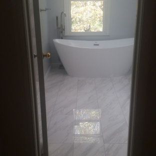 A bathroom with a freestanding tub and a window.