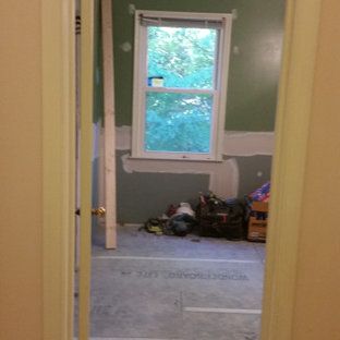 A room with a window and a box on the floor.