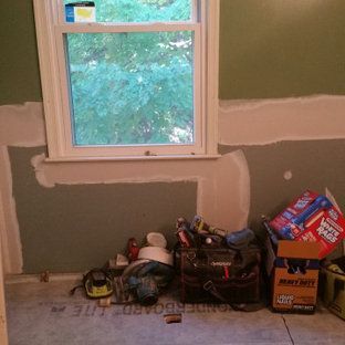 A room with a window and a bunch of tools on the floor.