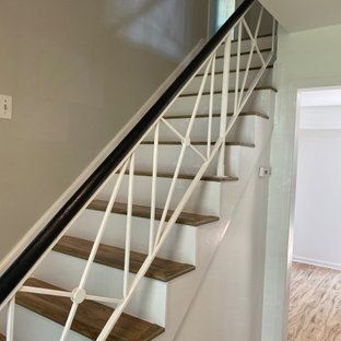 A staircase with a white railing and wooden steps in a house.