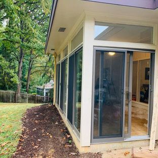 A house with a lot of windows and sliding glass doors.