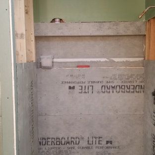 A shower stall is being built in a bathroom.