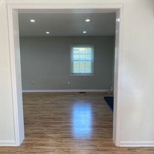 A living room with hardwood floors and a window.