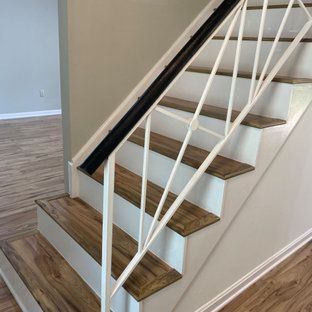 A staircase with wooden steps and a white railing in a house.