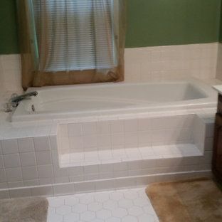 A bathroom with a bathtub and a window.