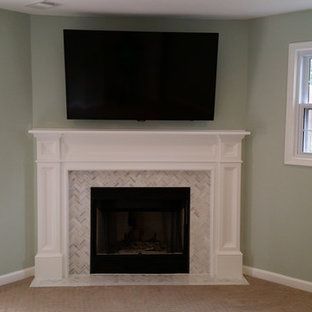 A living room with a fireplace and a flat screen tv above it.